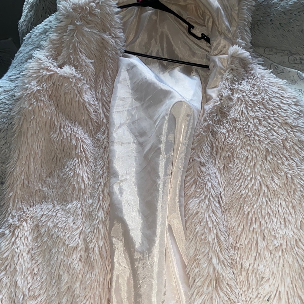 Pastel peach fluffy vest with a hood